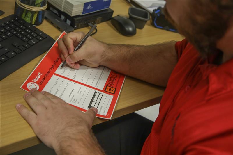 An Strata employee looking at computer monitors of live operations
