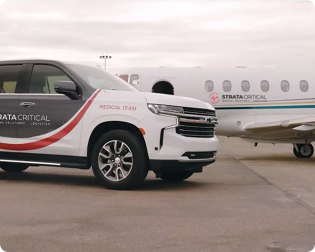 Strata Critical Medical Team SUV and private jet parked on tarmac under cloudy sky.