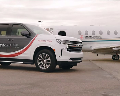 Strata Critical medical team SUV parked near a Strata Critical private jet on an airport tarmac.