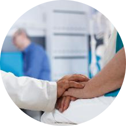 Doctor holding a patient’s hand in a comforting gesture in a medical setting.