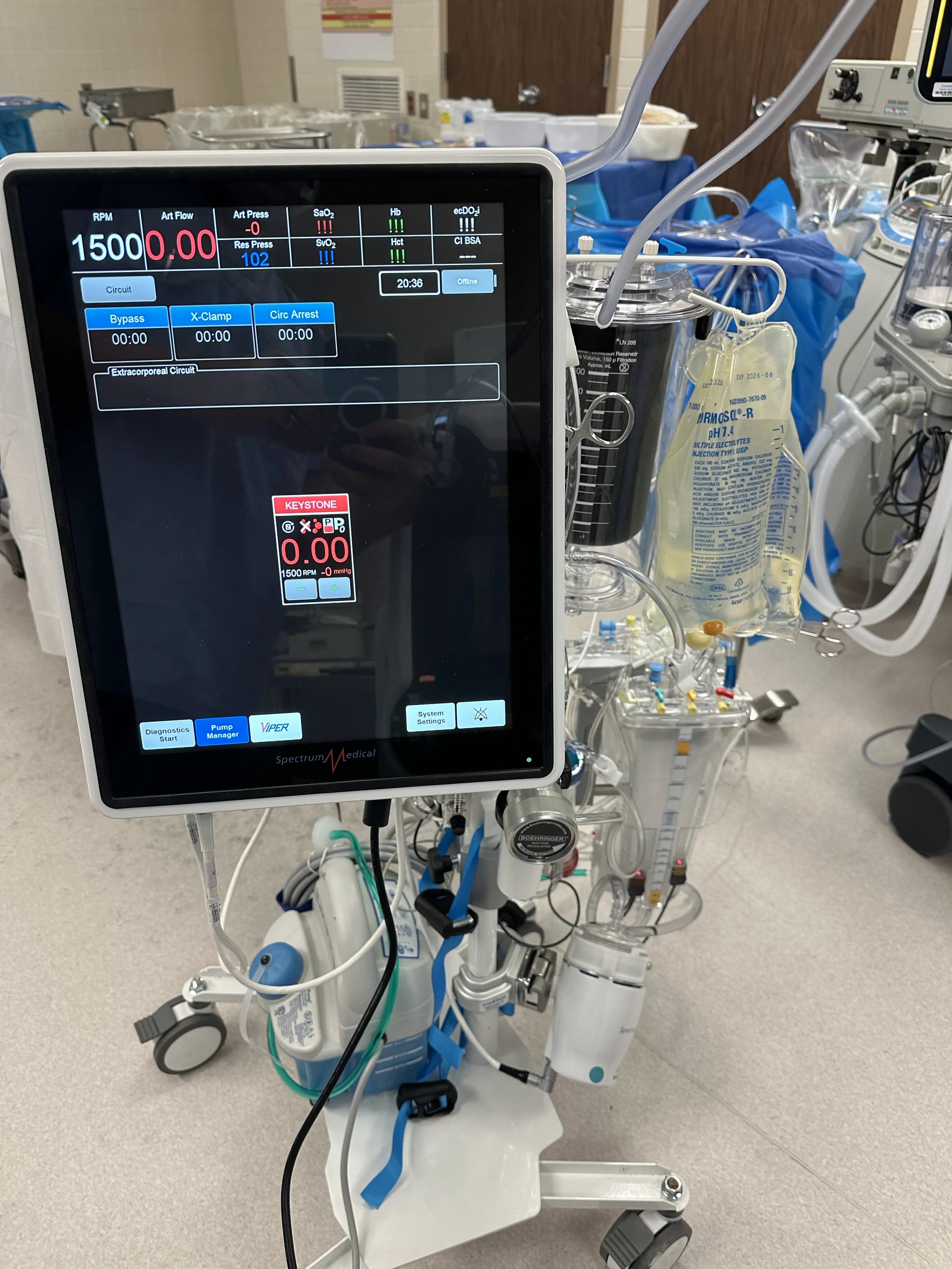 Medical machine with digital display and blood tubing, likely a dialysis or blood processing device.