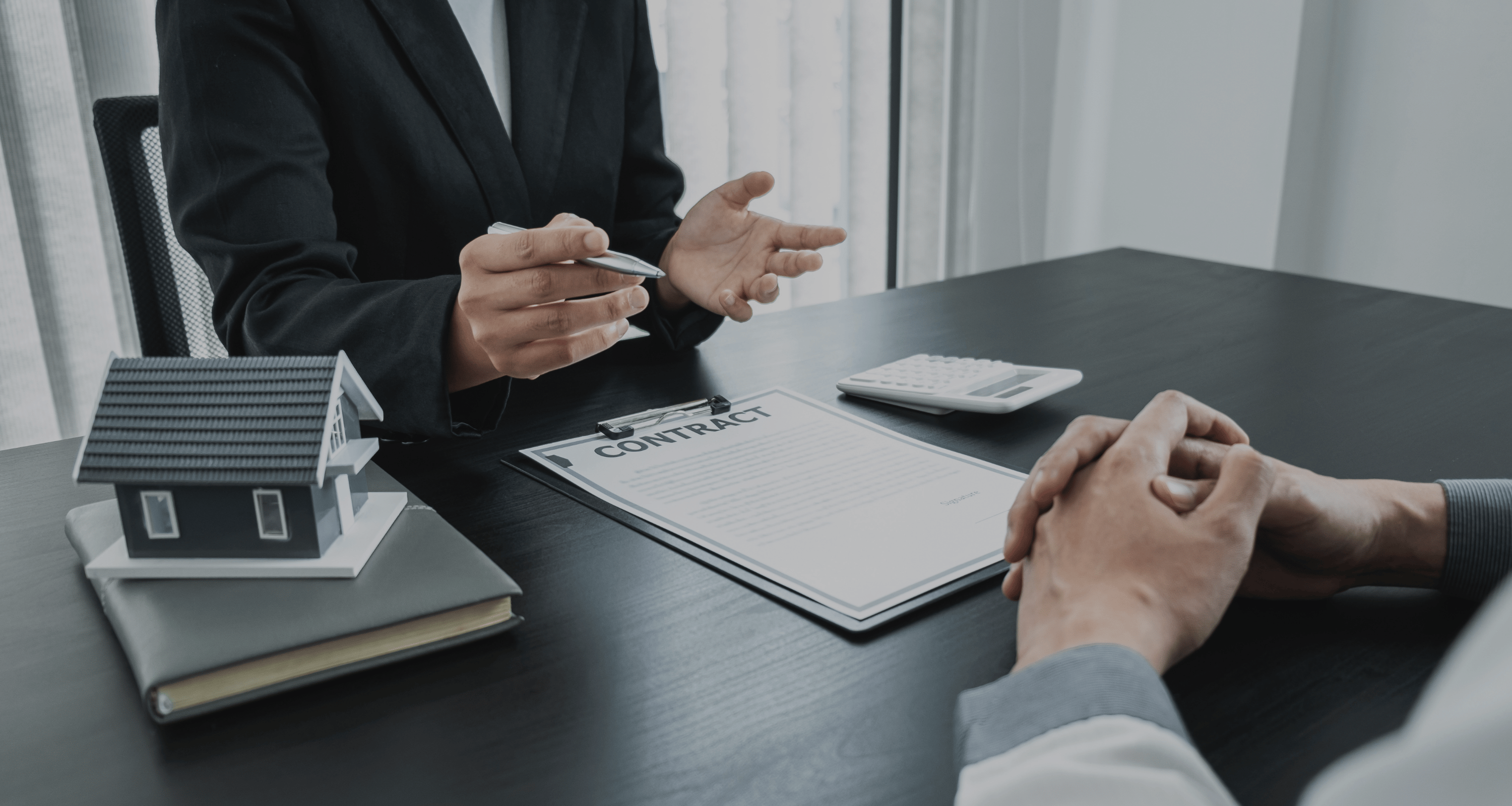 Real estate agent consultation at eRealty Advisors discussing 100% commission brokerage model with no hidden fees.