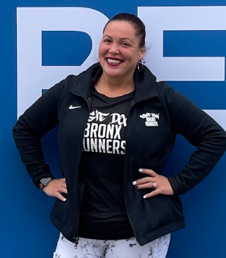 N. Lopez-Watson smiling in Bronx Runners shirt and jacket