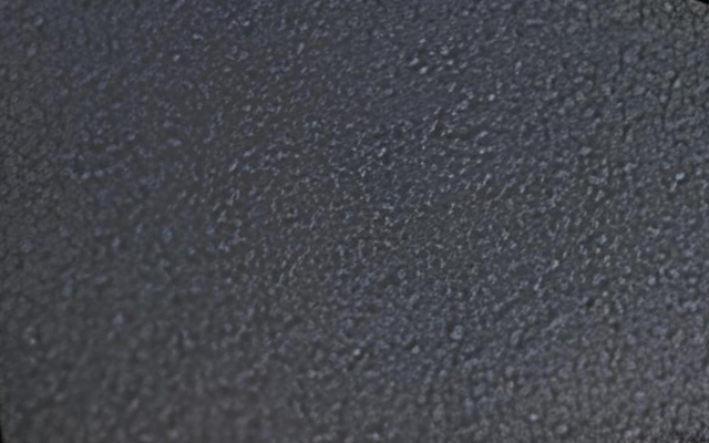 Close-up of a textured black surface.