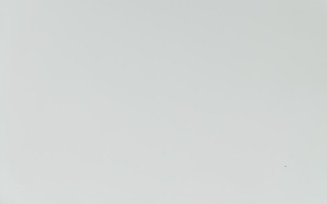 A plain, light grey background.