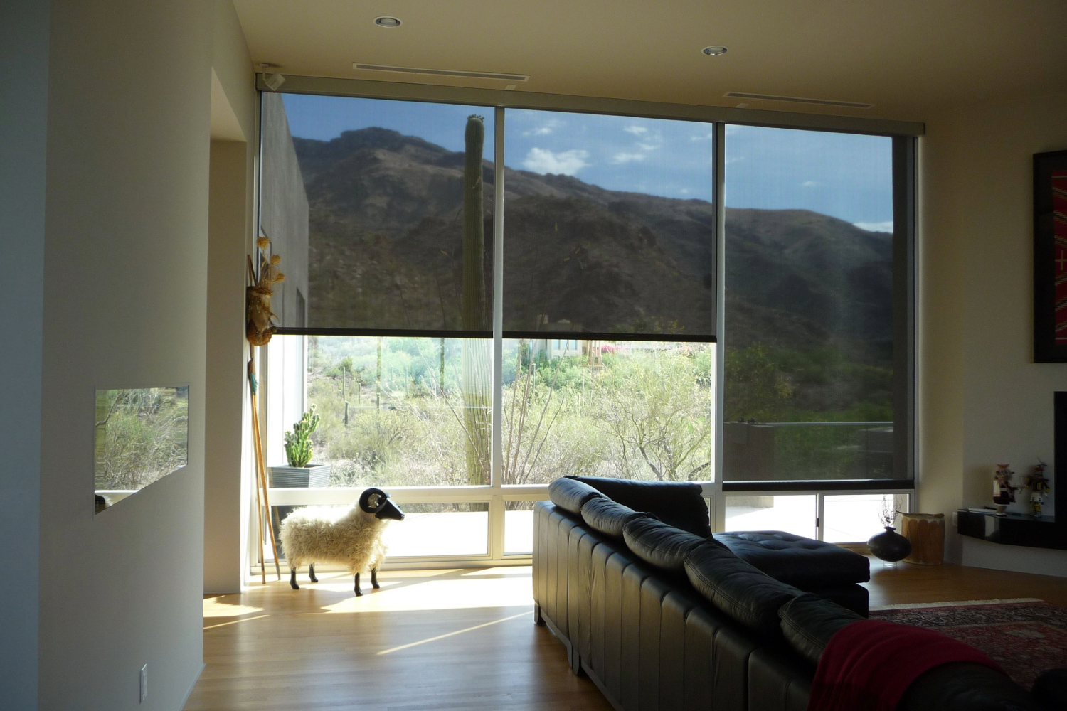 Living room with solar screens showing desert view