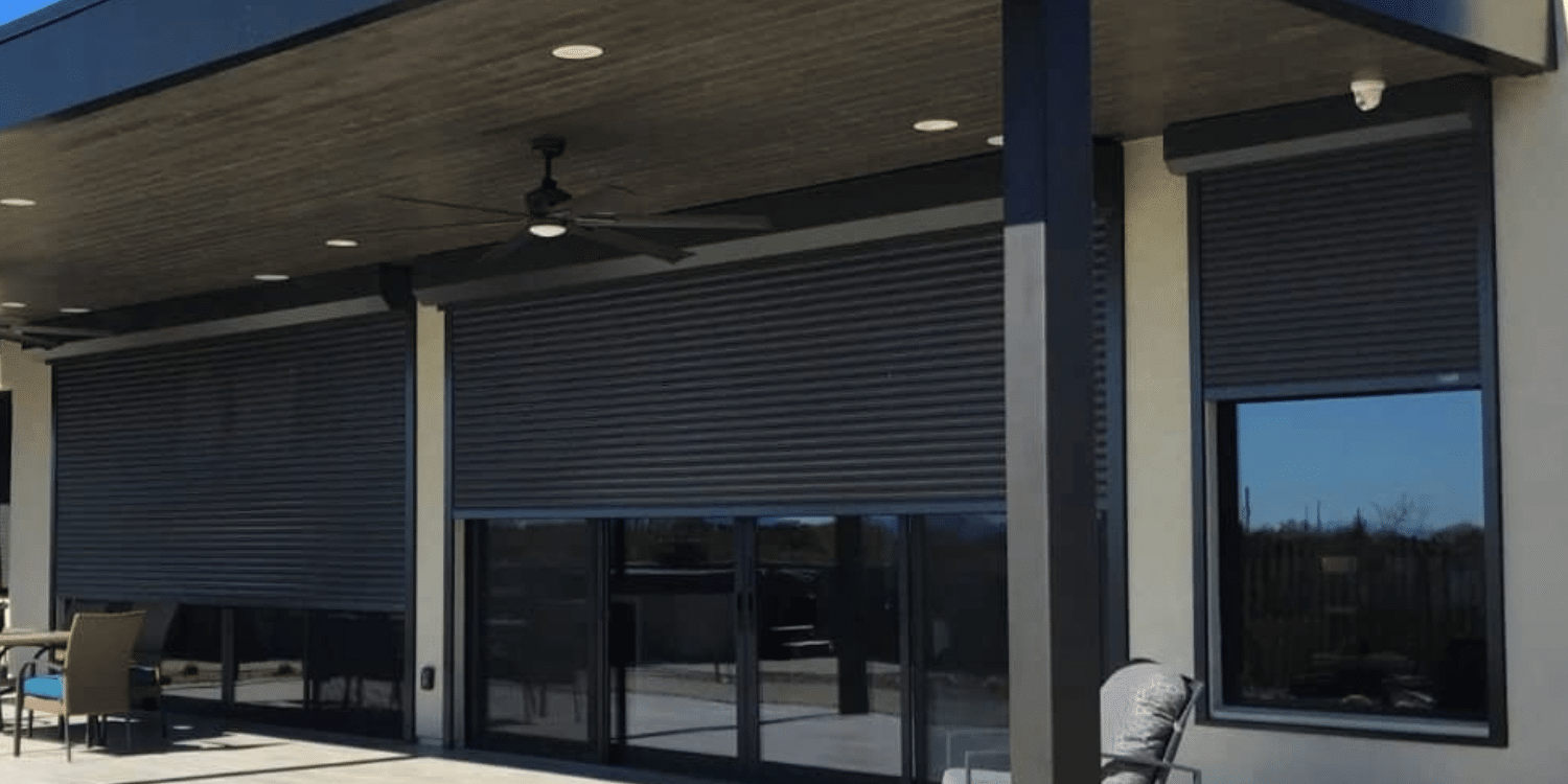 Modern patio with black rolling shutters.