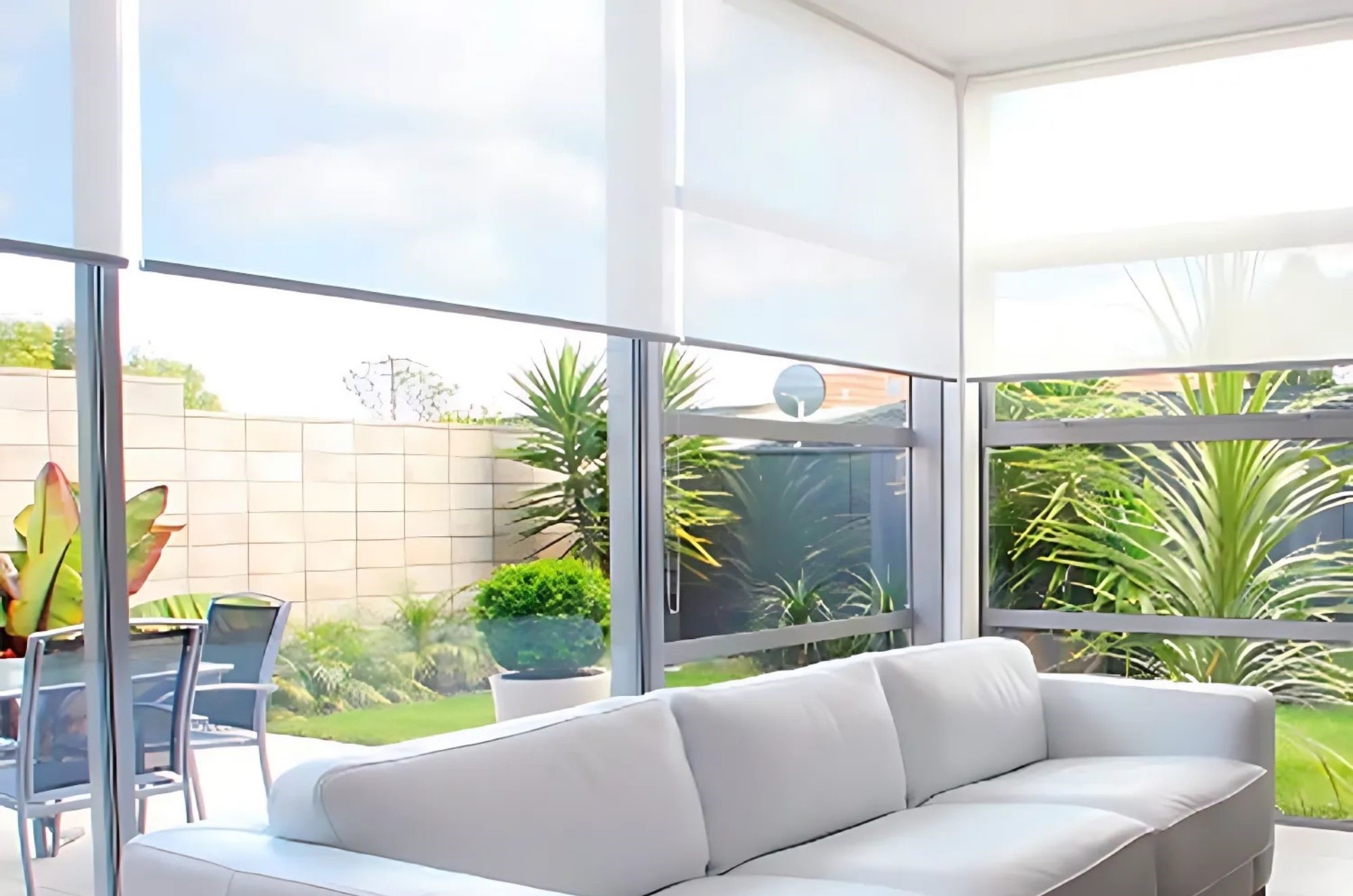 Modern living room with solar screens and garden view.