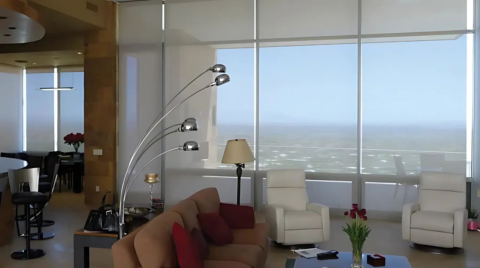 Modern living room with solar shades, Tucson view