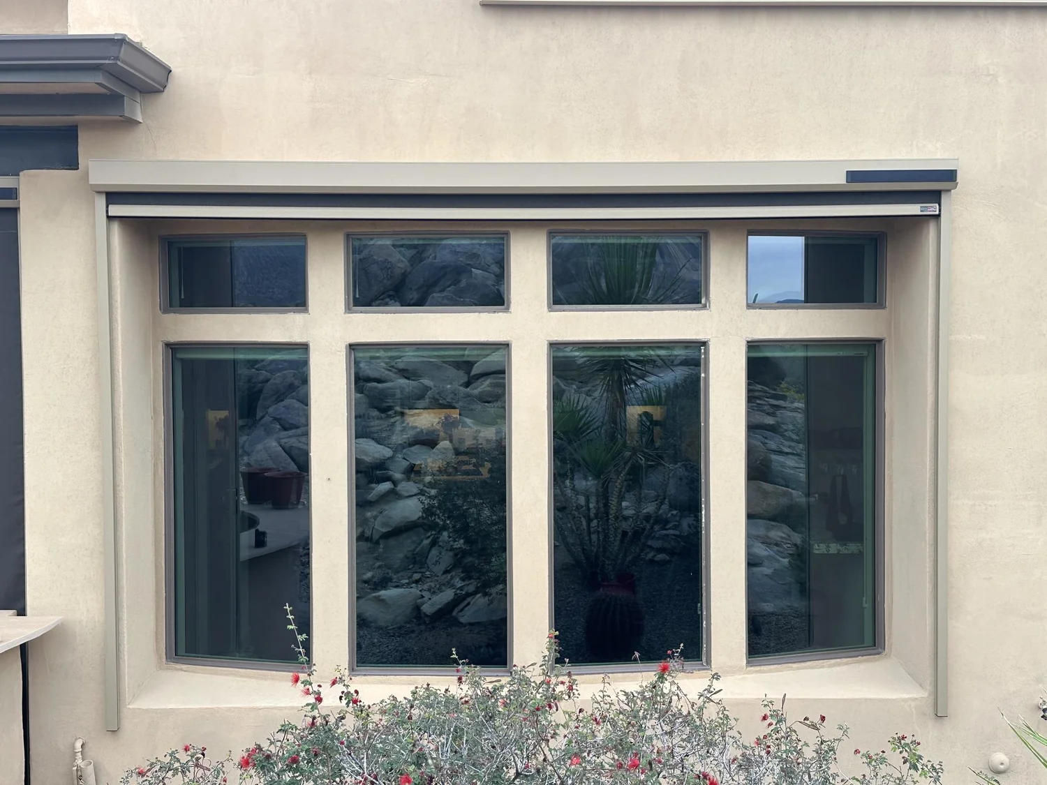 Wide exterior window on stucco home ready for solar screen installation