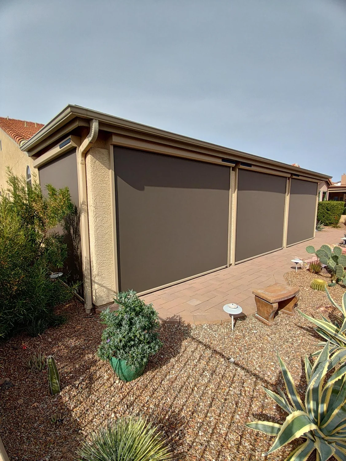 Solar screens installed on large covered patio structure with desert landscaping