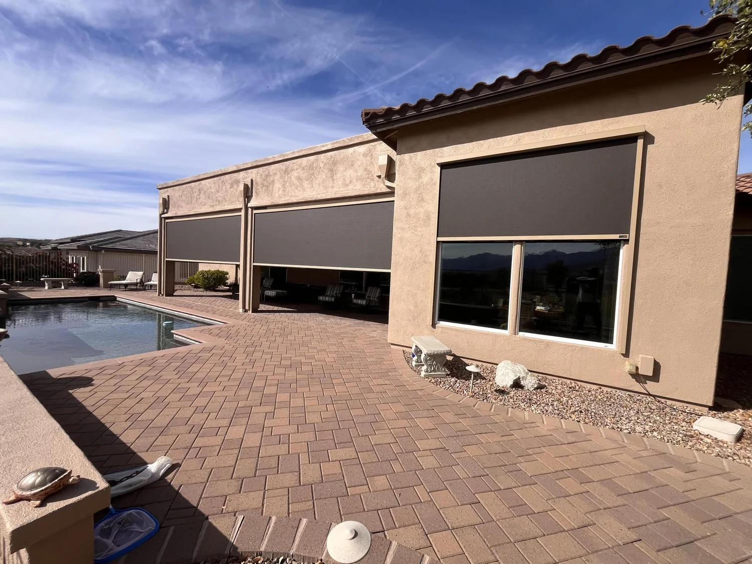 Solar screens installed on large covered patio structure with desert landscaping