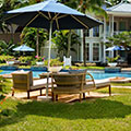 Two cozy lounge chairs beside a tranquil pool, framed by tropical foliage—perfect for unwinding under the Mauritian sun.