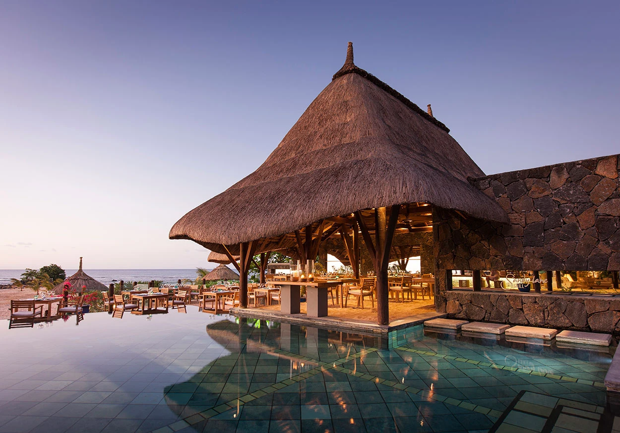 Beachfront deck with cushioned lounge chair, flowering railings, and ocean view in Mauritius—Island Lilly’s tranquil space for private relaxation and coastal serenity