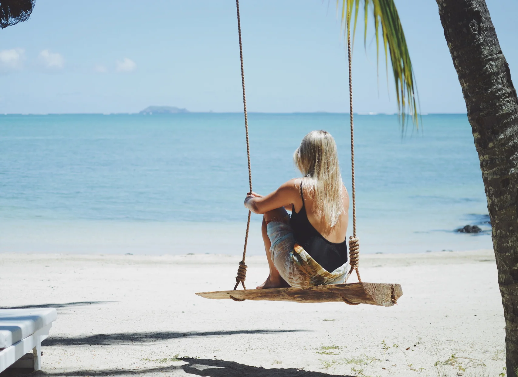 Verdant waterfall landscape in Mauritius with cascading cliffs and tropical foliage—Island Lilly’s immersive nature retreats rooted in serenity and renewal
