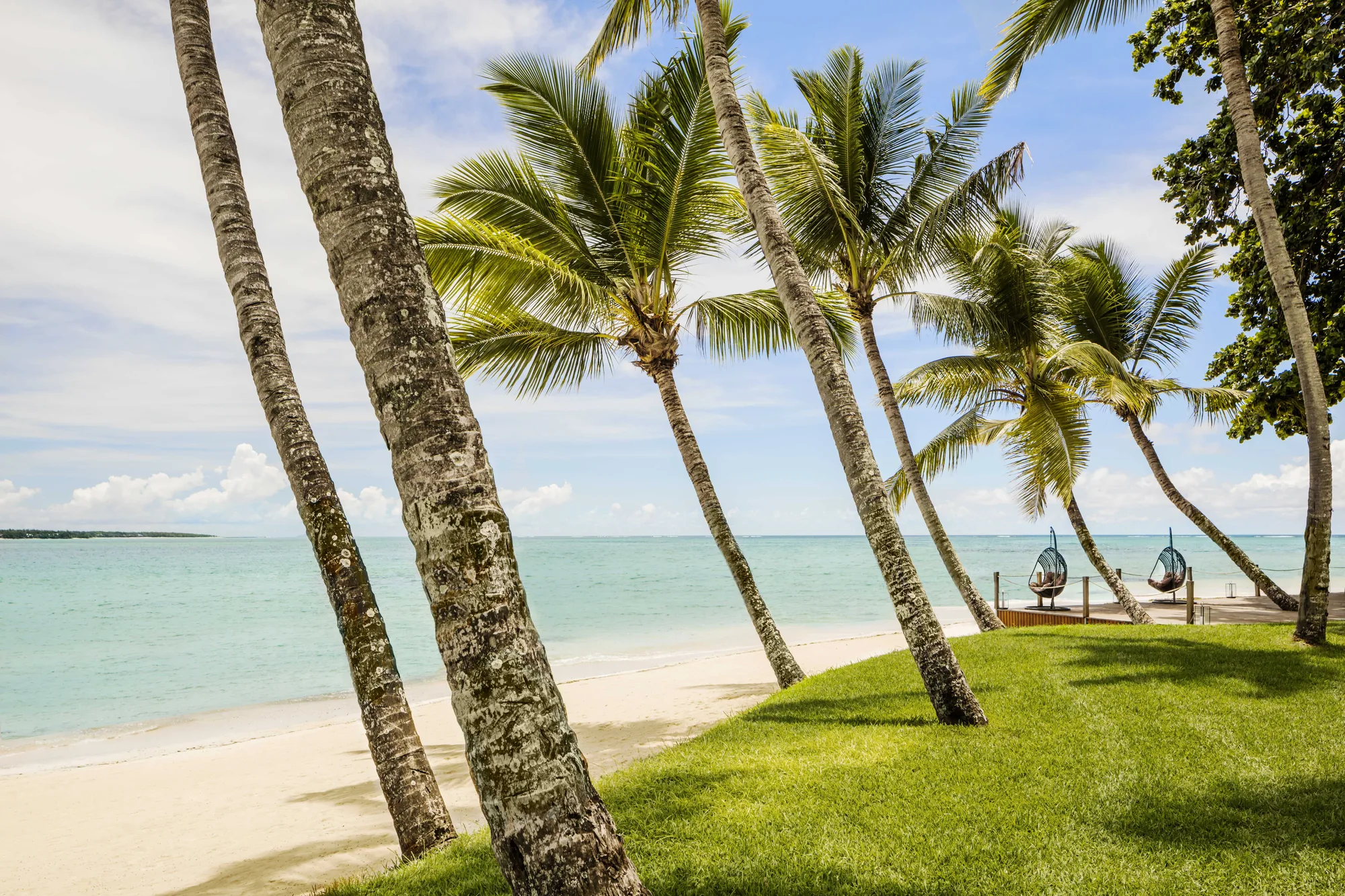 Verdant waterfall landscape in Mauritius with cascading cliffs and tropical foliage—Island Lilly’s immersive nature retreats rooted in serenity and renewal