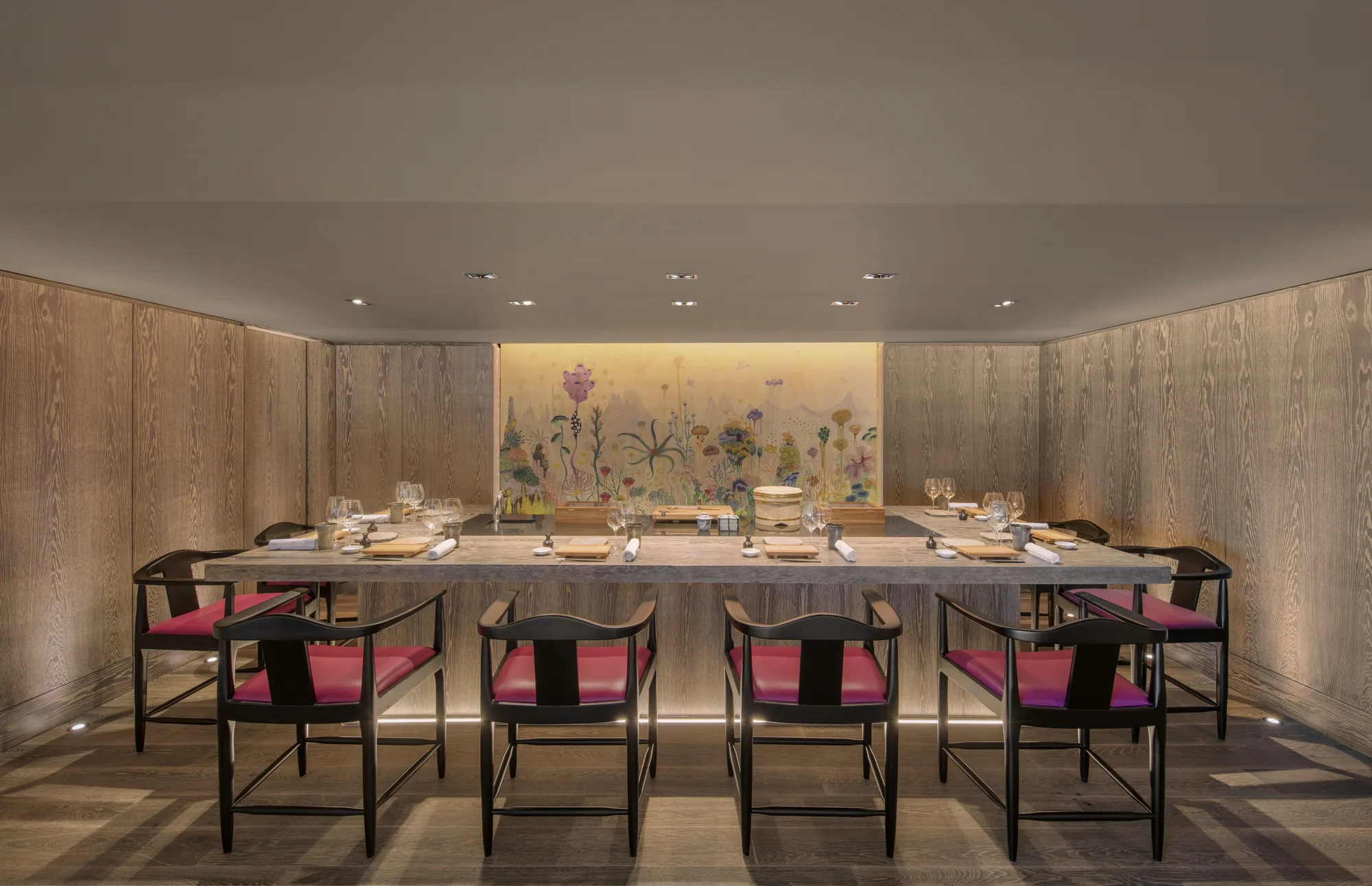 A private dining room with a long table and botanical artwork