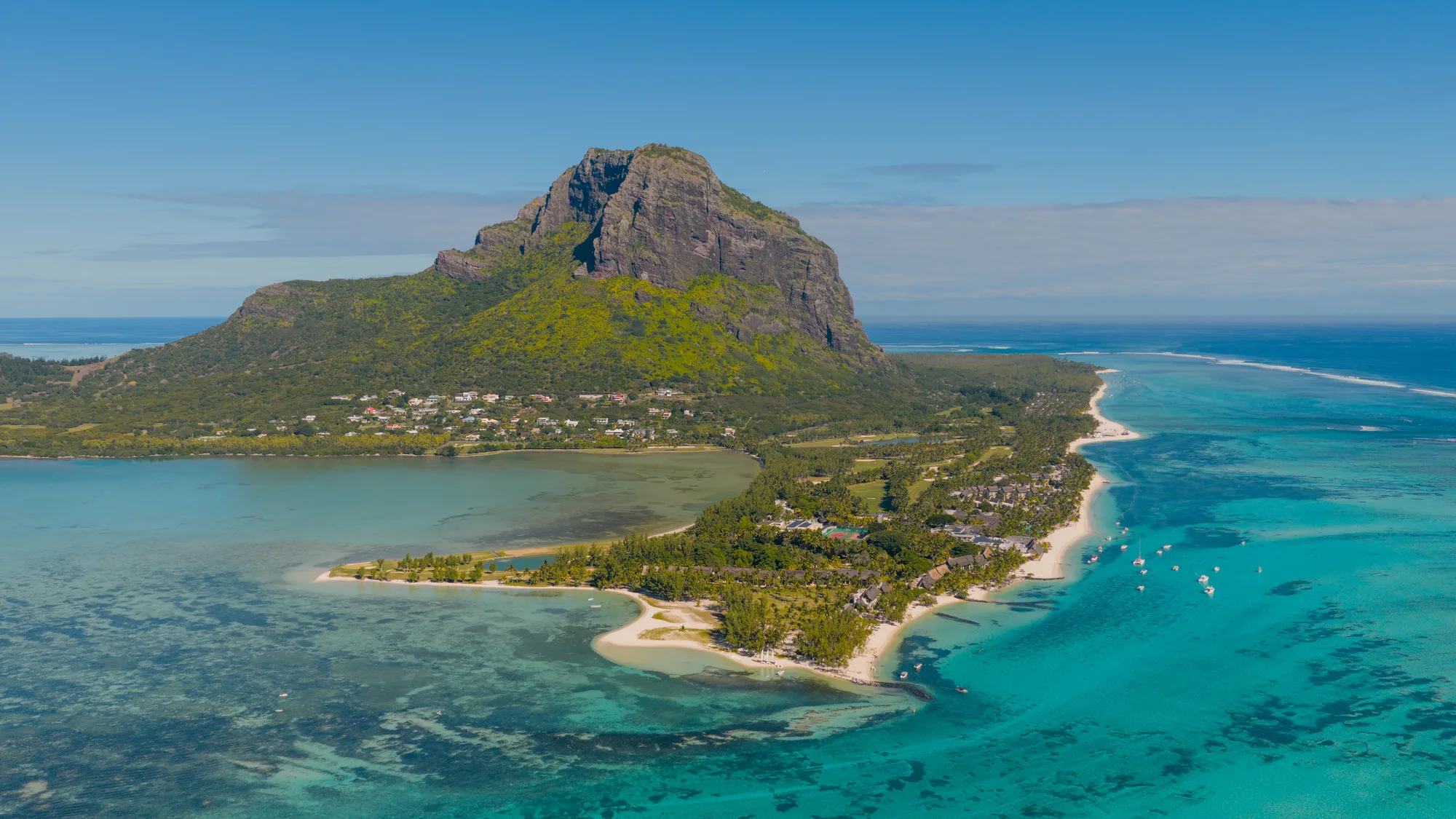 Aerial view of Paradis Beachcomber on its peninsula below Le Morne Brabant, ringed by lagoon