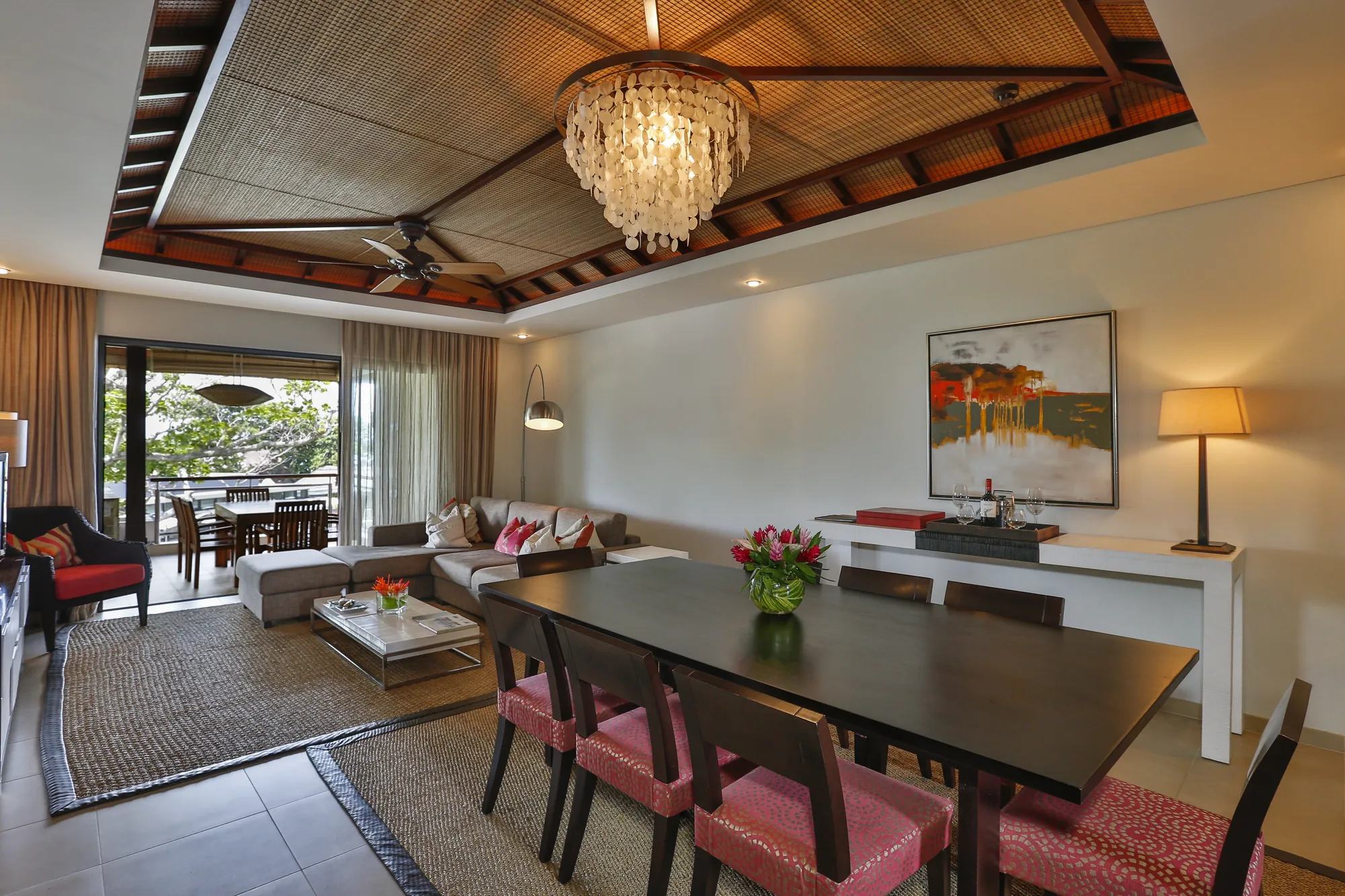 An open-plan villa living and dining room with a chandelier