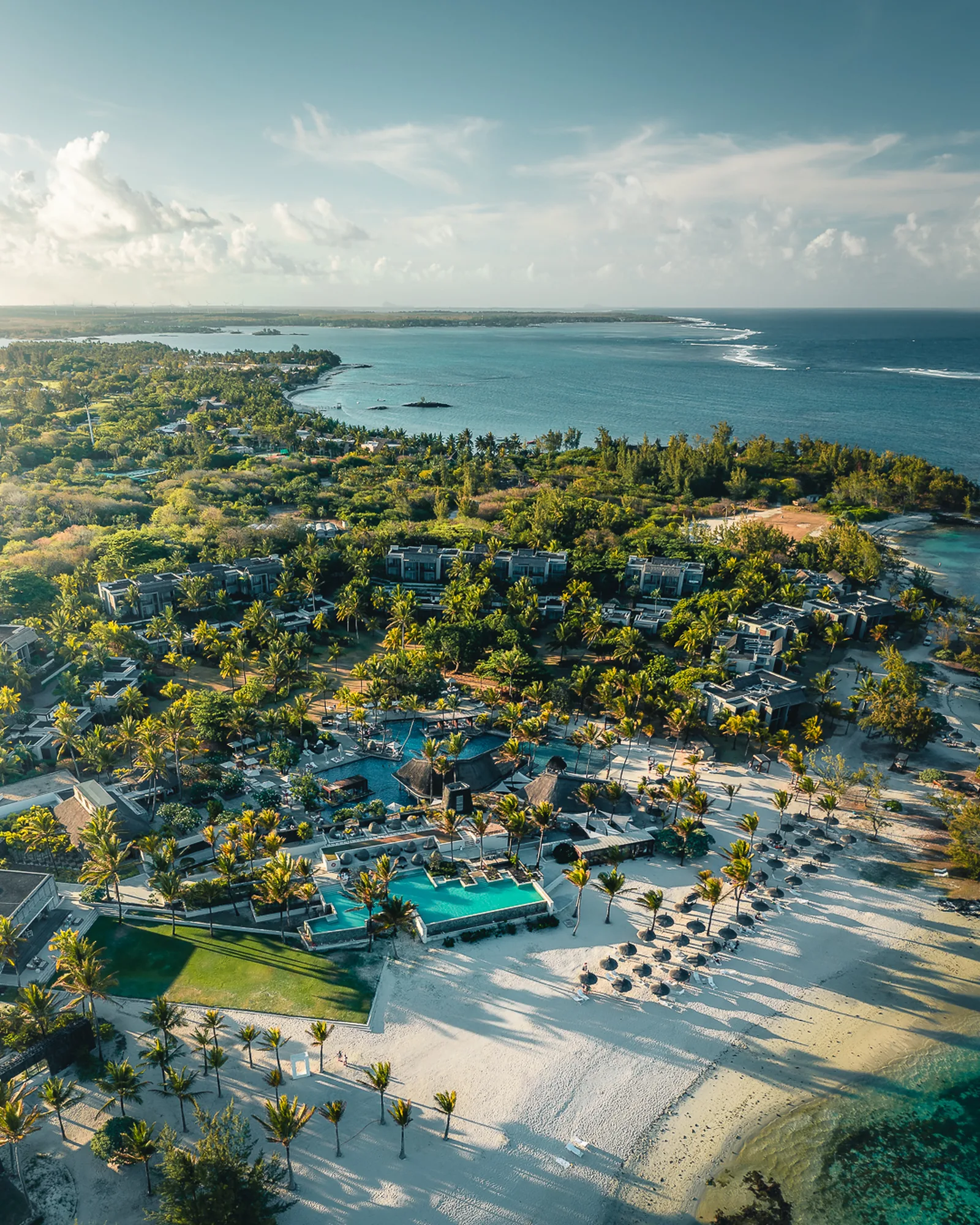 The resort's gardens, pools and beach along the coast, seen from above