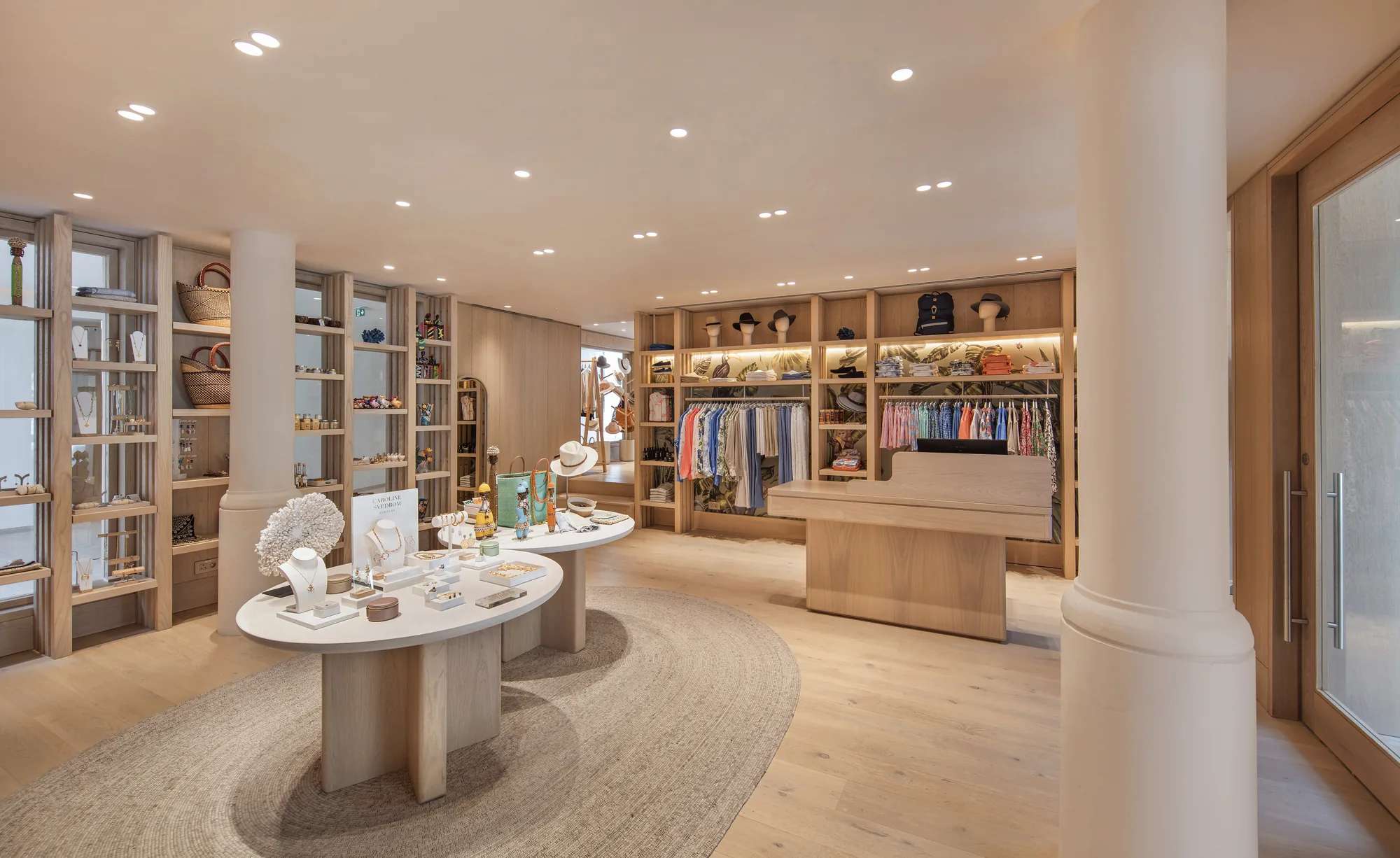 A resort boutique with clothes and accessories on timber shelving