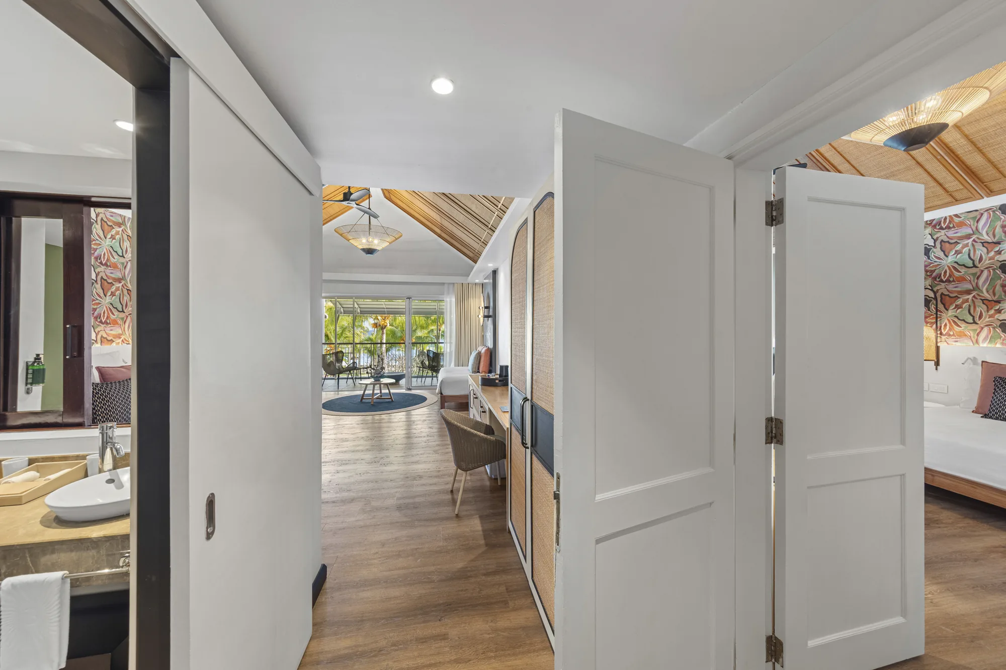 A room seen through an open doorway, with the bedroom and bathroom either side