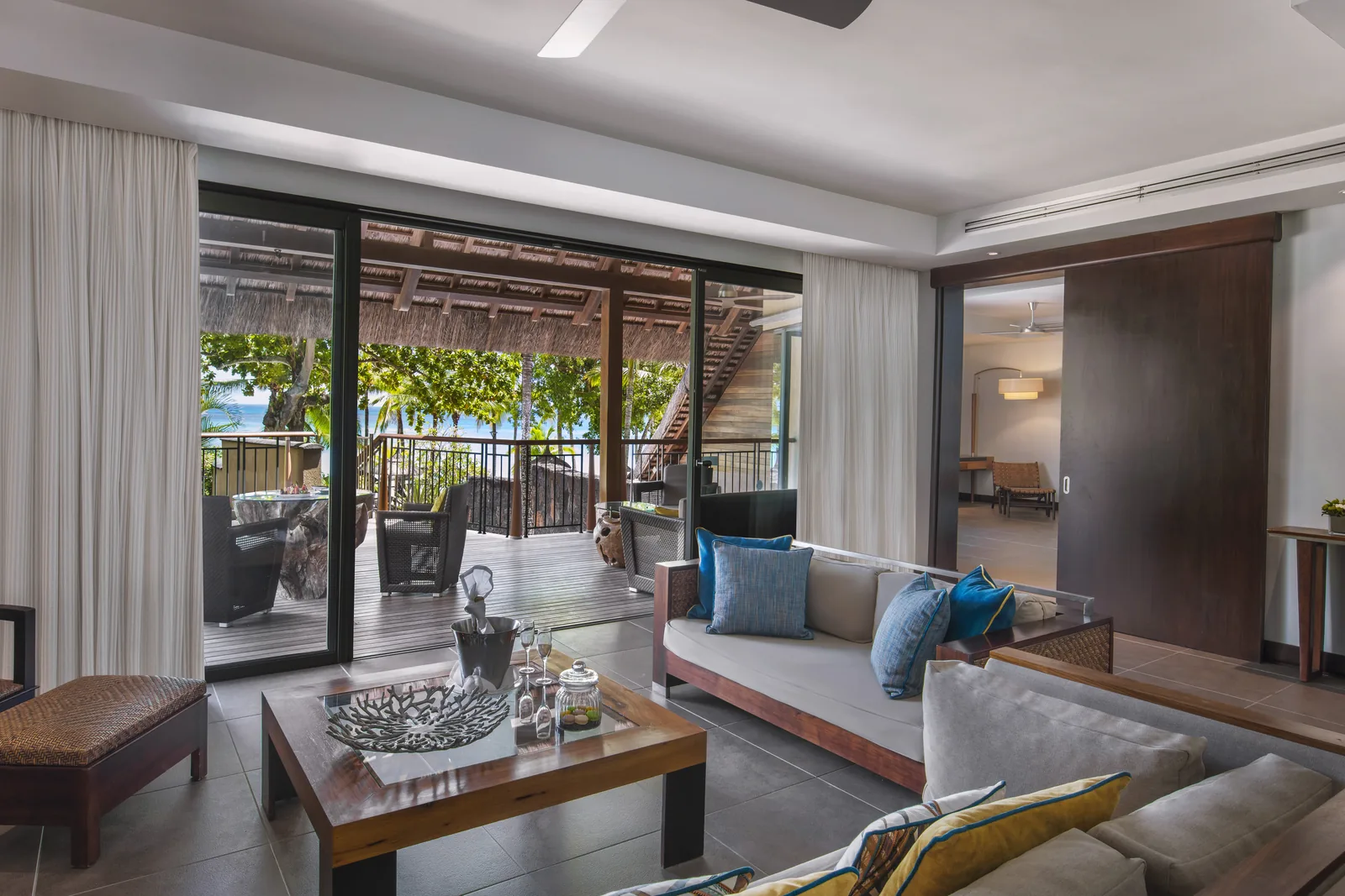 A suite sitting room with sofas, opening onto a terrace