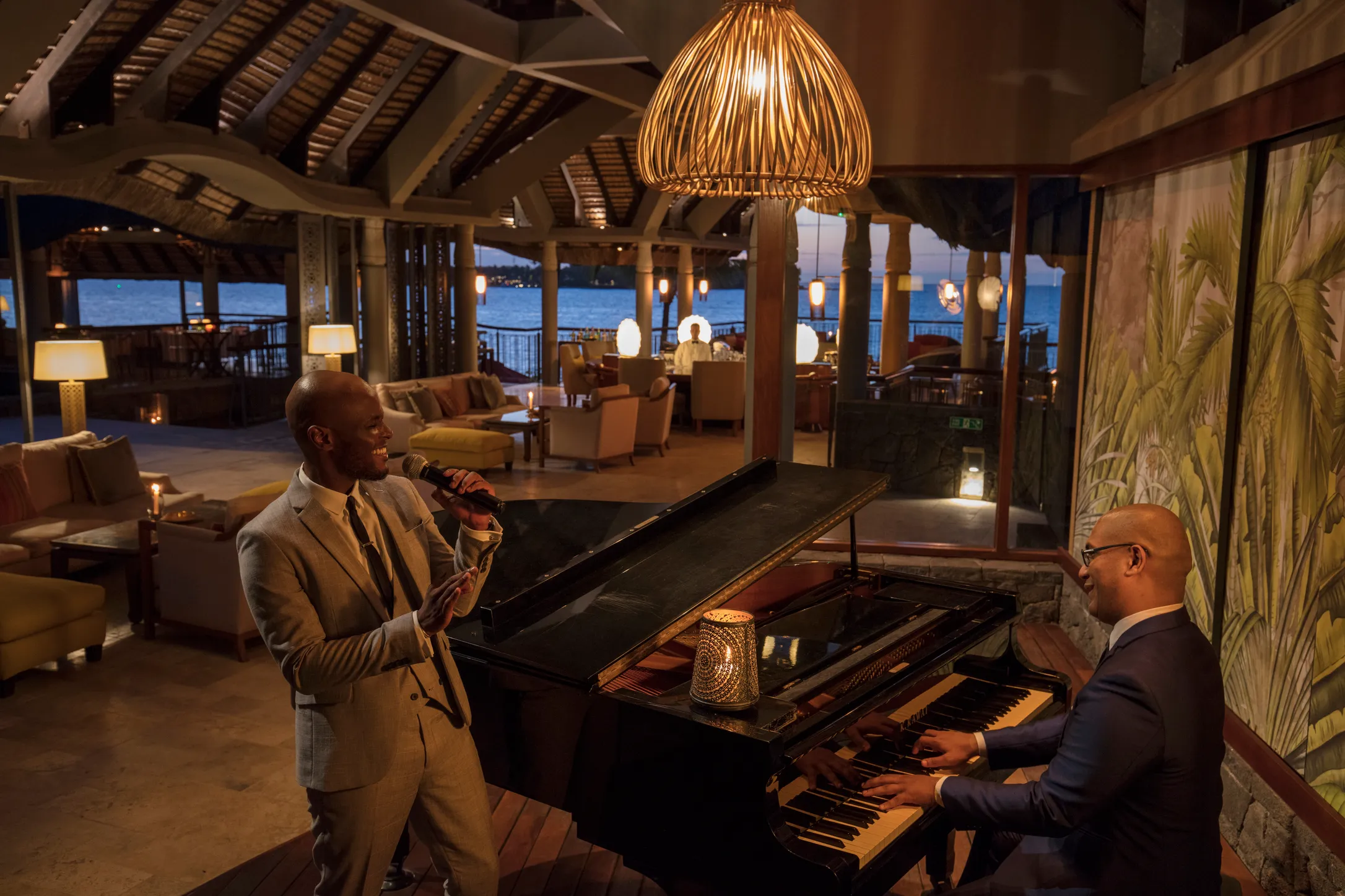 A pianist and a saxophonist playing in the bar in the evening