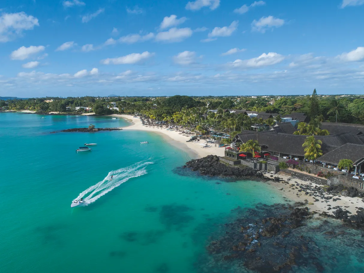 The Grand Baie coastline from above, with boats on the lagoon beside the resort