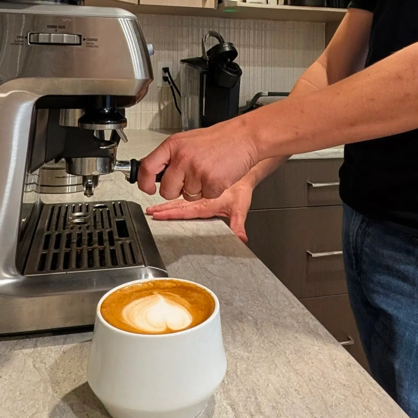 A man is making a cup of coffee.