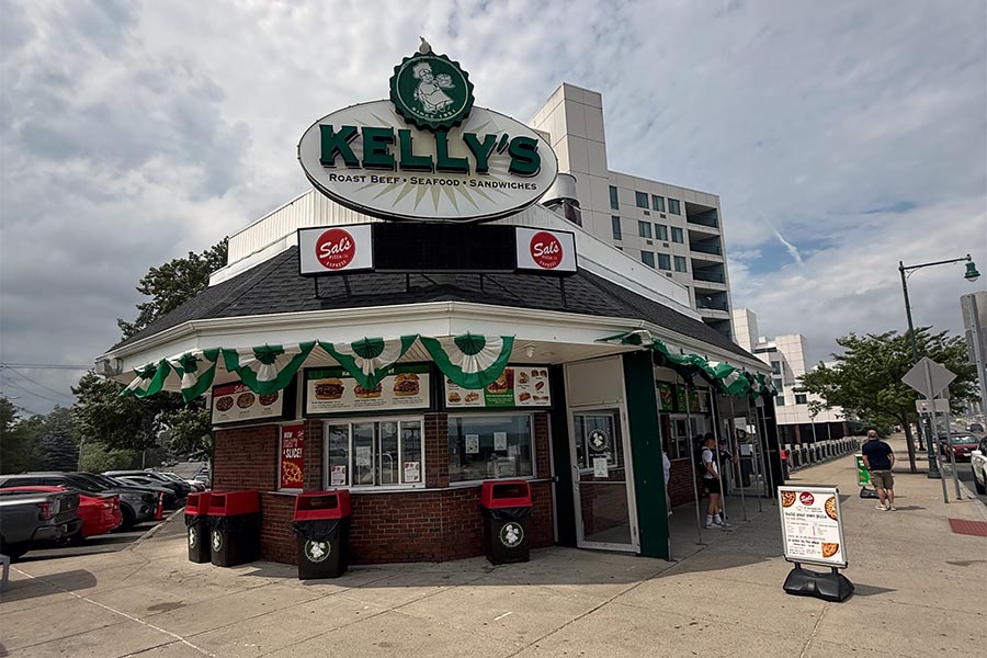 Kelly’s restaurant, a brick building with a large sign, offers roast beef, seafood, and sandwiches on a city street corner.