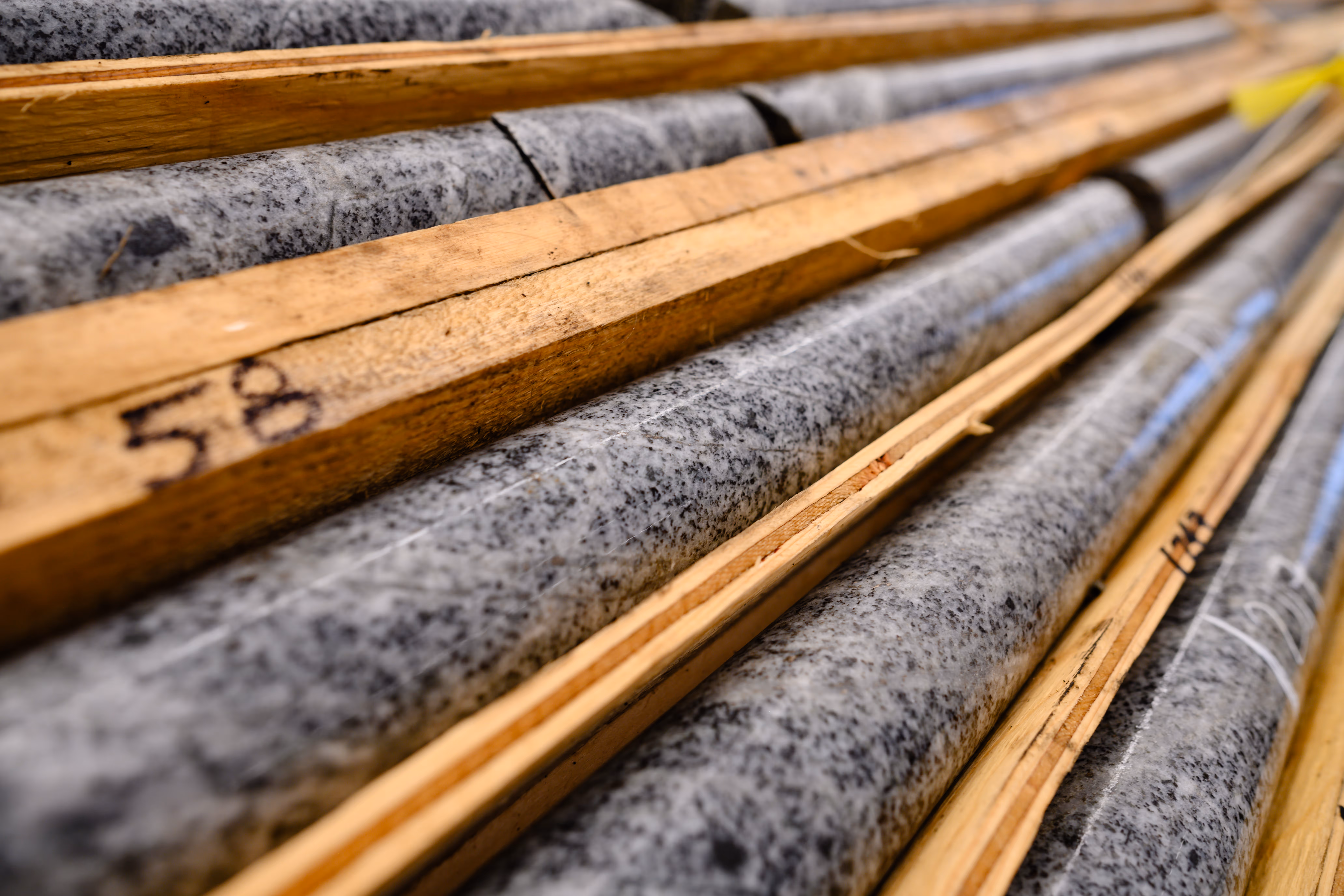 Mining core samples with number 58 written on a wooden beam