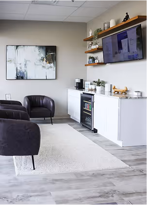 Modern ThrIVwell consultation lounge with plush seating, soft lighting, and calming spa inspired medical design. 