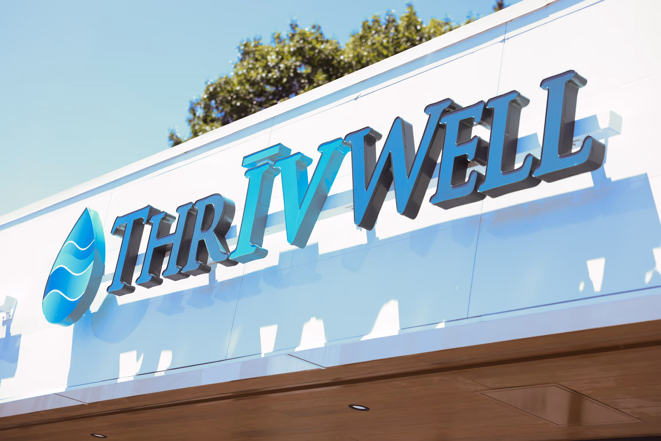 ThrIVwell clinic sign on building exterior in Saugus, MA, showcasing luxury wellness and IV therapy branding