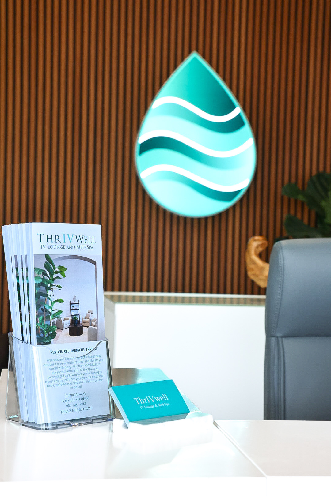 Man seated in a private IV chair wearing a spa robe at ThrIVwell