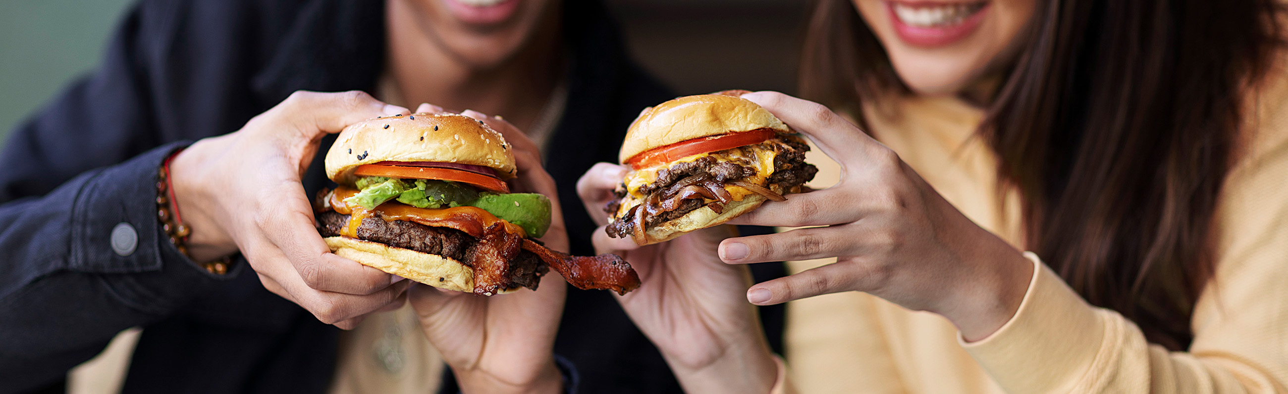 A couple of people that are holding some food.