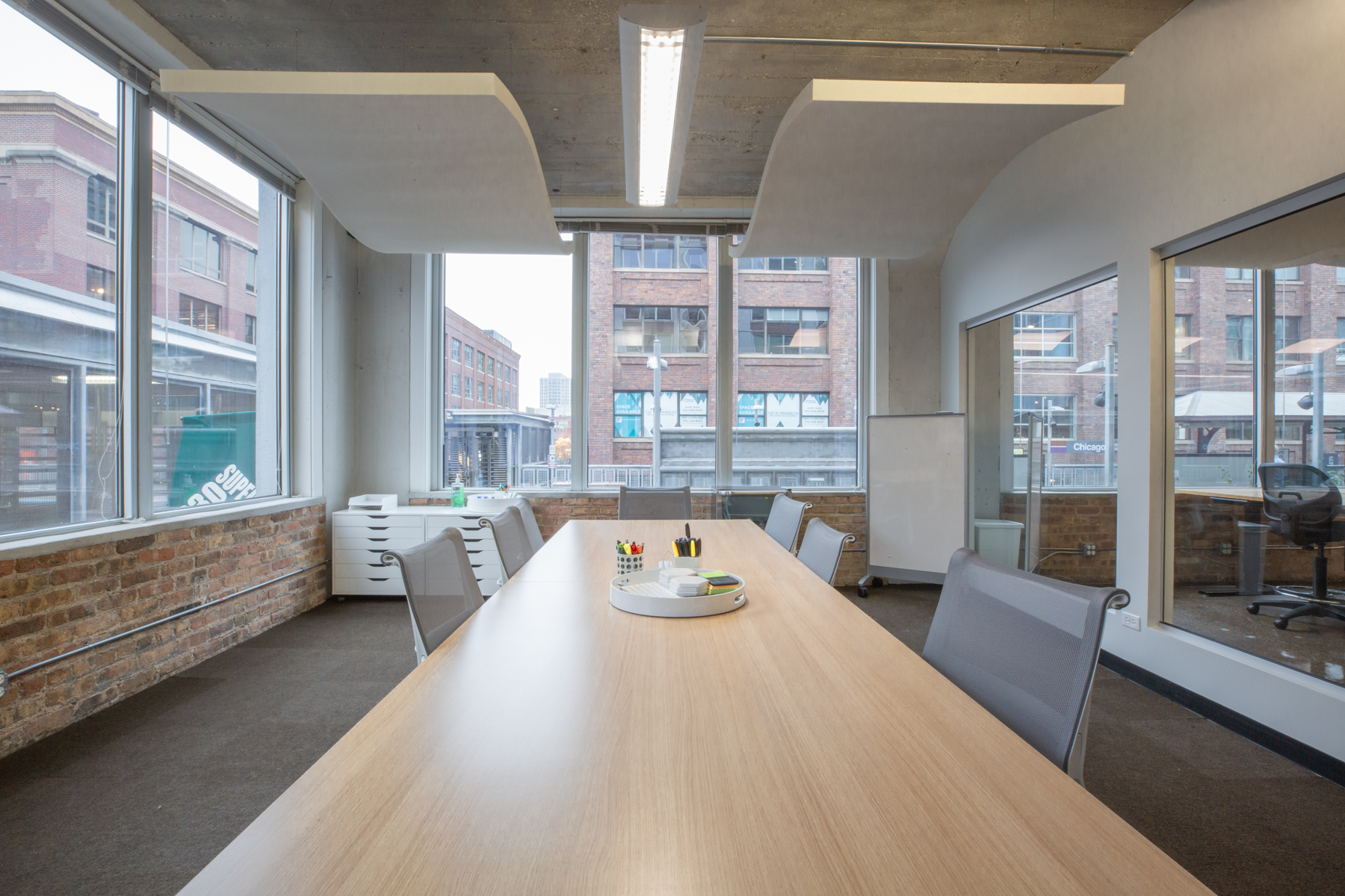 3:0 Conference Room corner view with large windows and presentation display