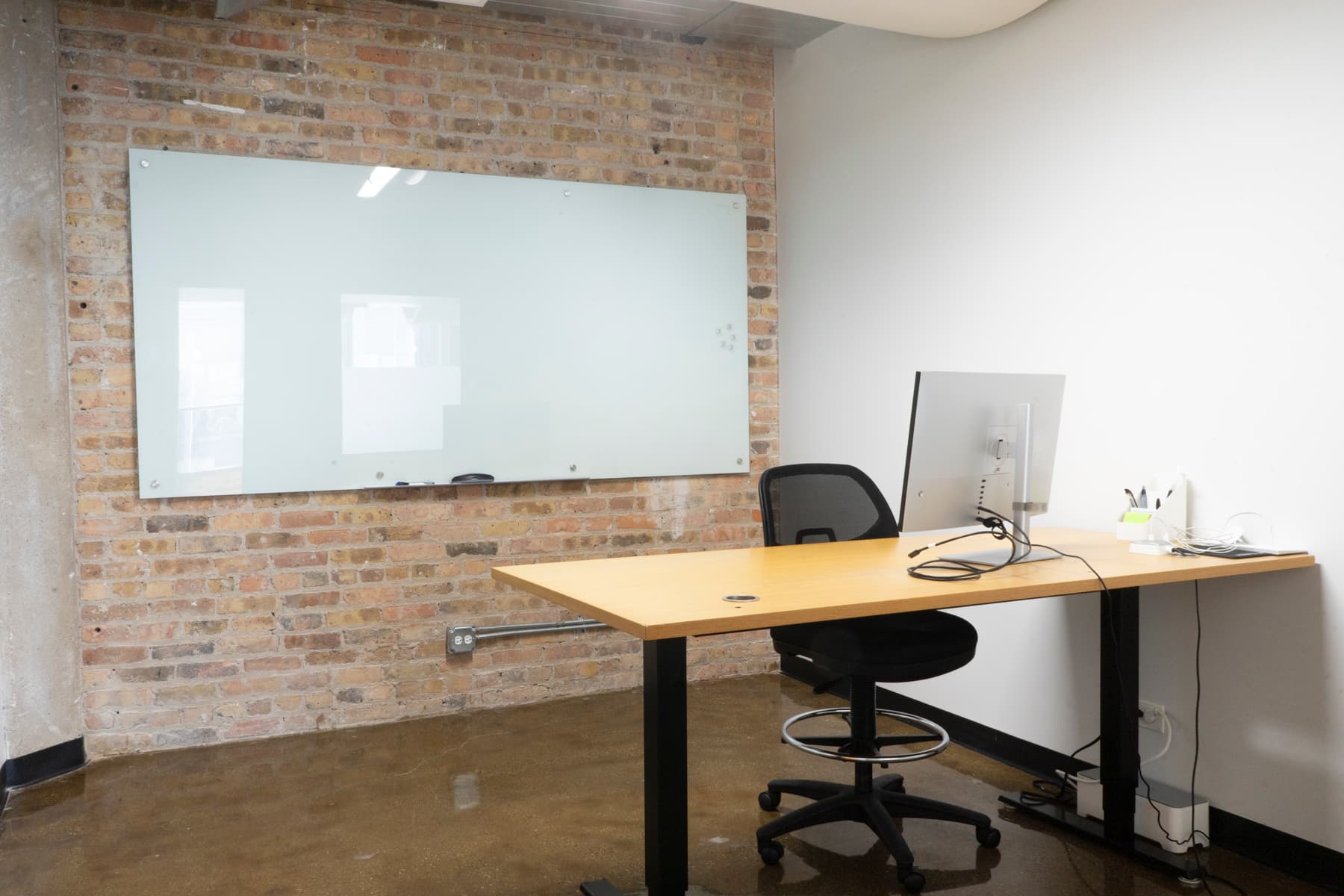 3:4 Private Office at Two Thirty with monitor, sit-stand desk, and whiteboard