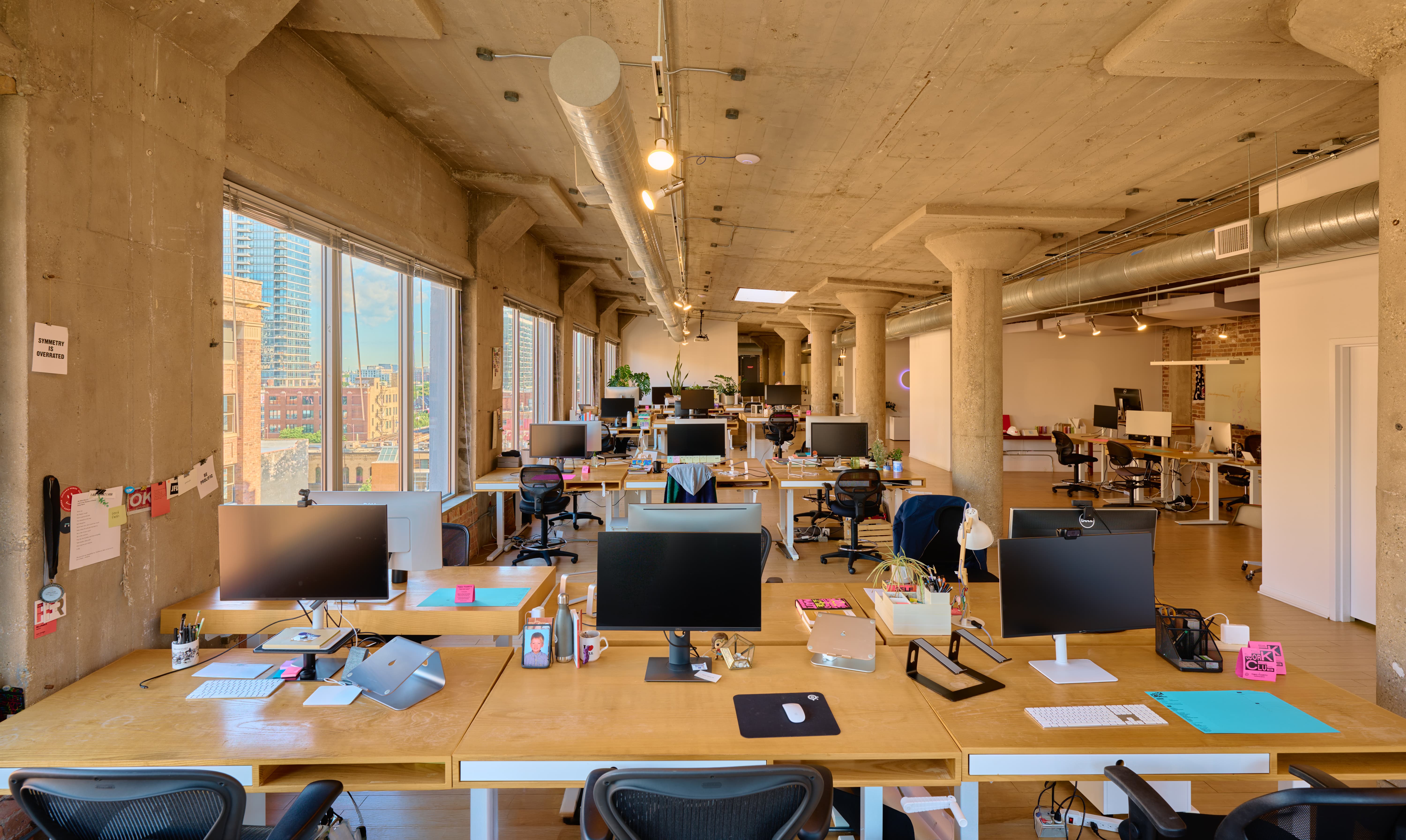 The Complete Workspace Loft at Two Thirty, a 7th-floor River North office with desks, monitors, and skyline views