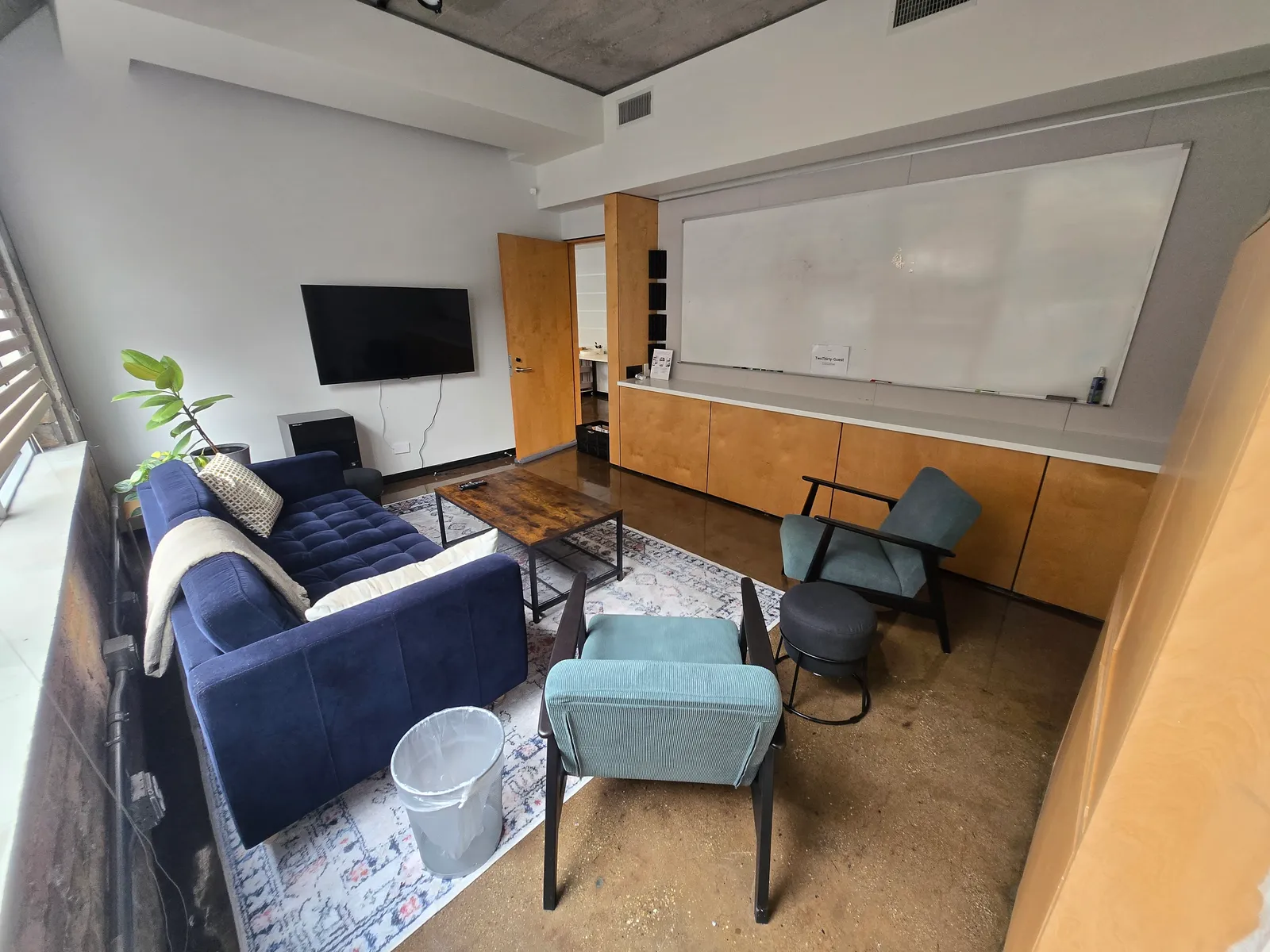 Full whiteboard wall and wall-mounted monitor in the 3:5 Collaboration Room