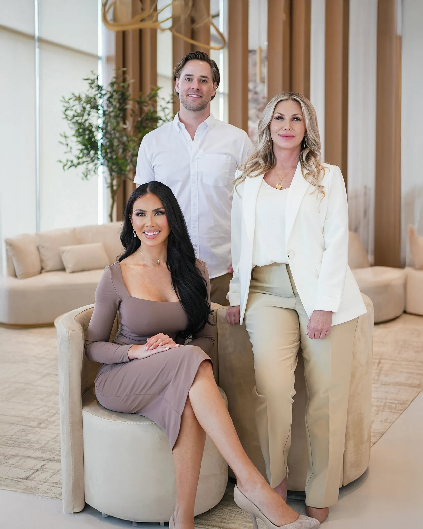 A few people sitting and standing in a foyer area