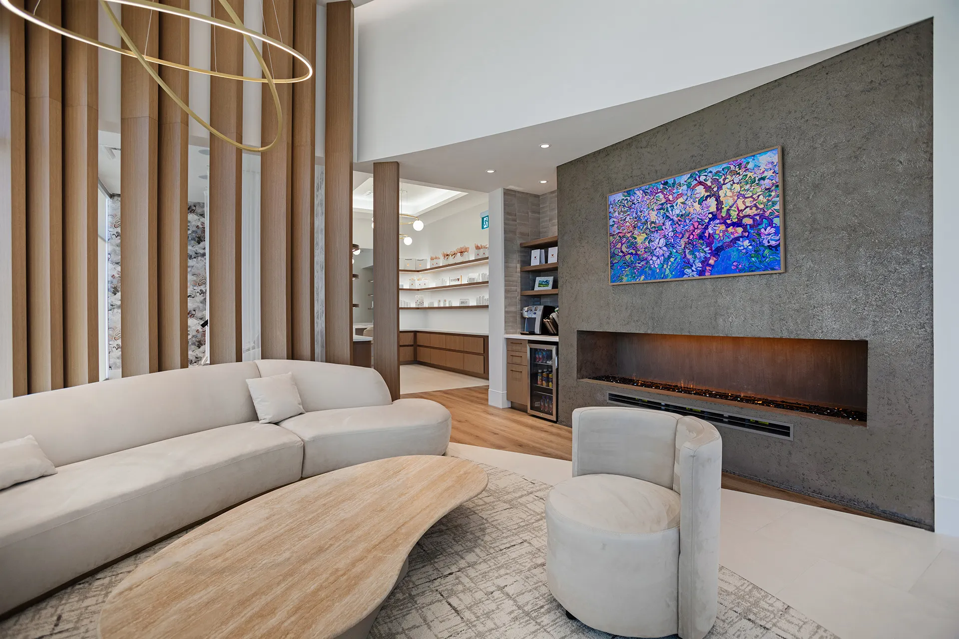 A living room with a large painting on the wall.