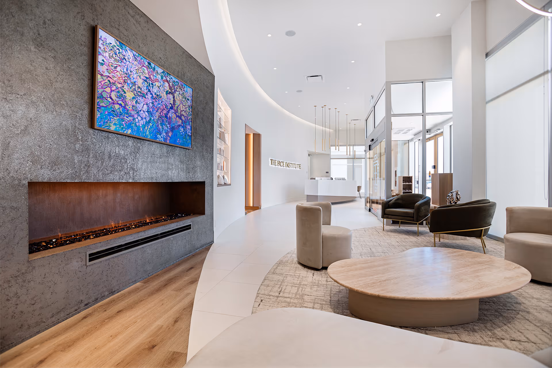 An interior view of a foyer with coffee table, chairs and fireplace
