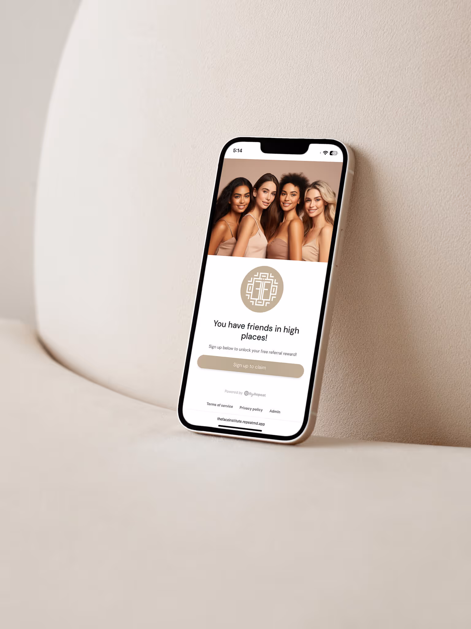 Smartphone displaying a referral reward sign-up page featuring four smiling women in neutral-toned outfits.