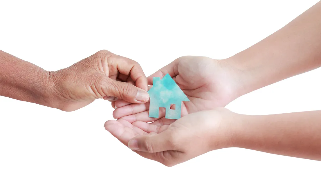 a person giving a paper home to another person