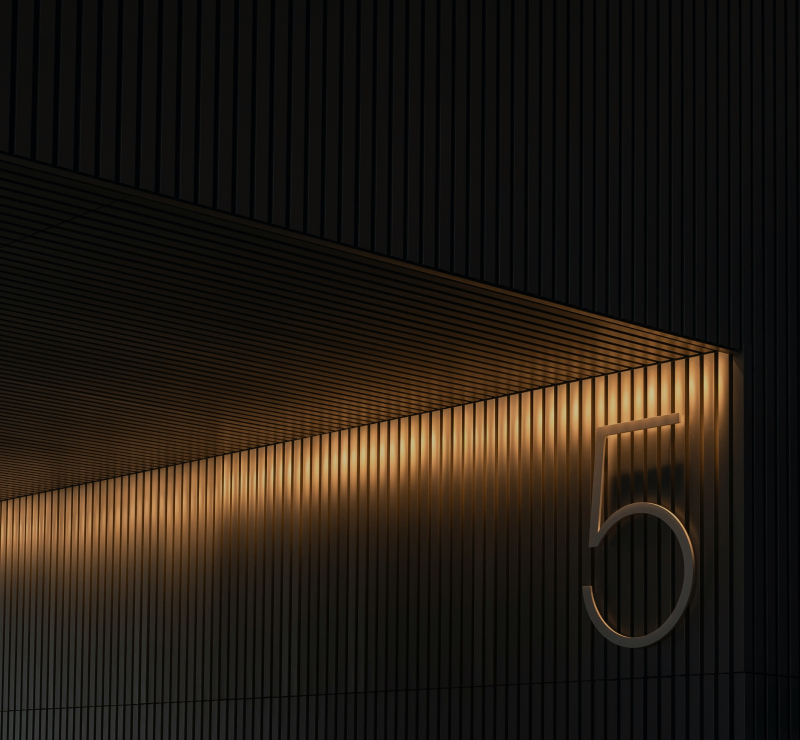 Black and gold building facade with number five.