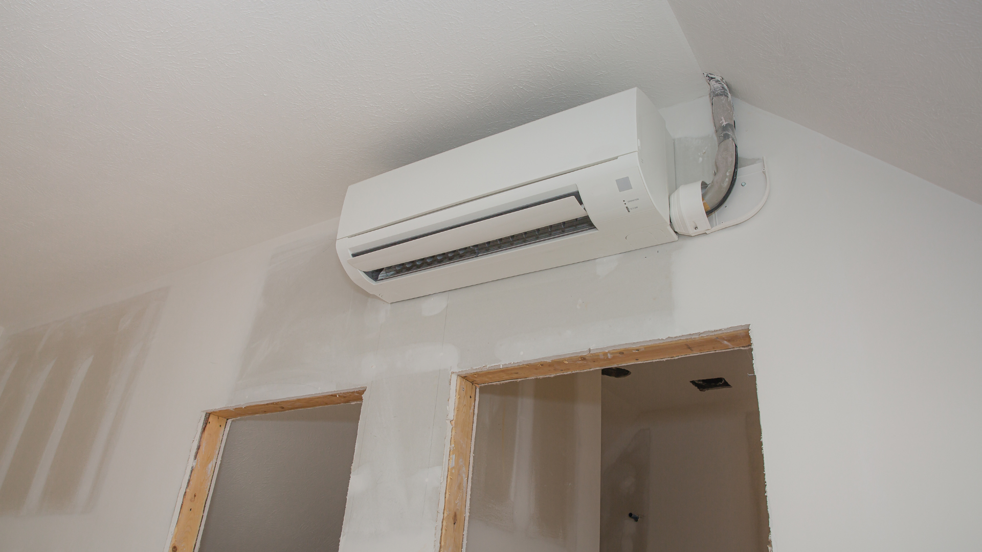 Ductless mini-split air conditioning unit installed on a wall, highlighting the importance of AC service before summer.