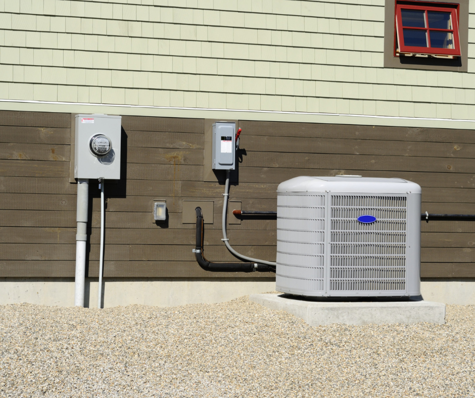HVAC system outdoor unit with electrical connections and gravel base, illustrating essential components for efficient heating and cooling in residential settings.