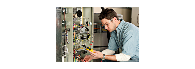 Image of a person checking the furnace