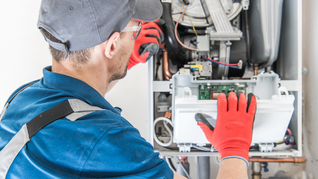 Picture of a man inspecting a furnace.